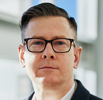 Ritratto di Alexander Hughes executive e CEO di azienda operante nel trading di criptovalute